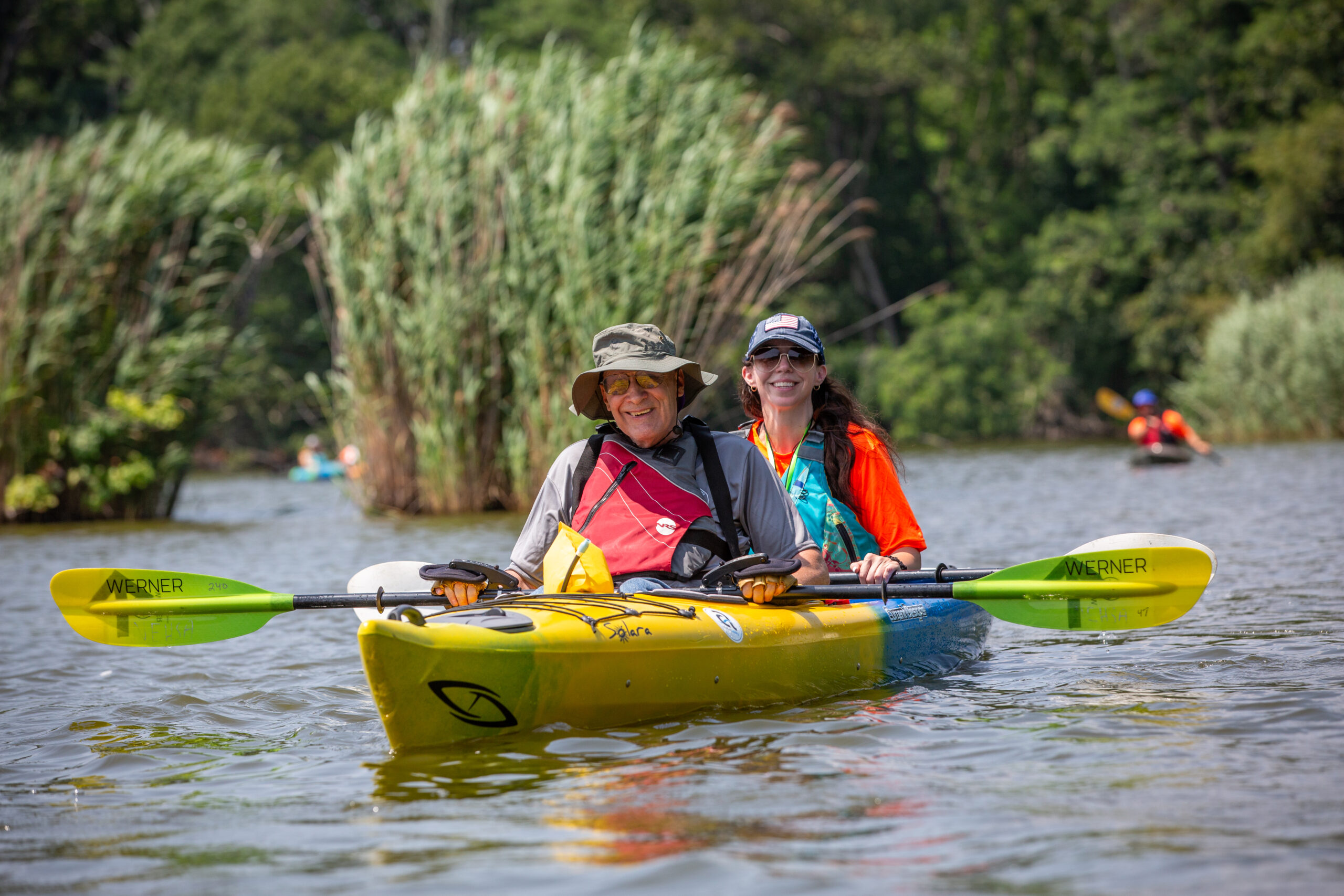 Disabled veteran and woman enjoy kayaking at the VA Summer Sports Clinic
