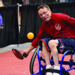Wheelchair athlete playing pickleball
