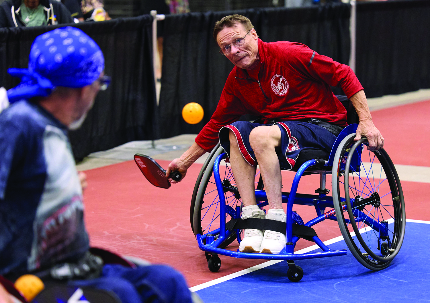 Wheelchair athlete playing pickleball