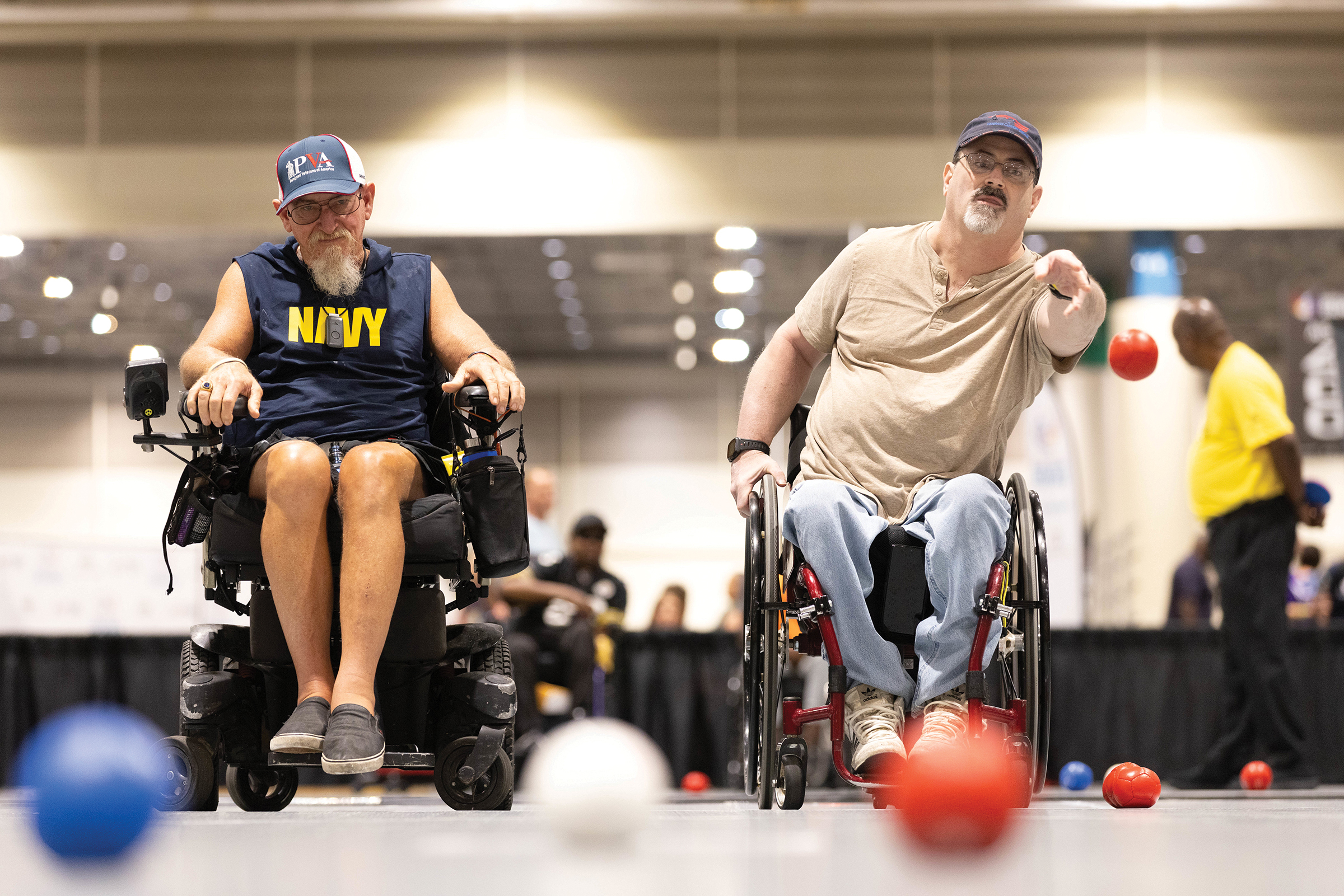 two men playing Boccia indoors