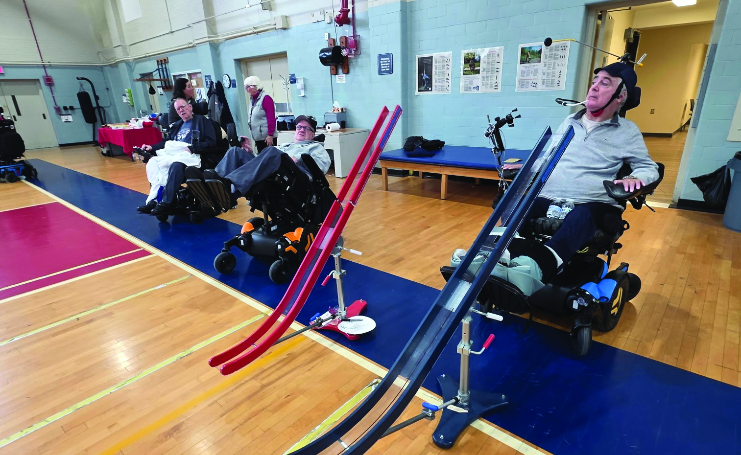 Veterans using power wheelchairs and ramps to play Boccia.