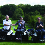 Three para golfers in adapted golf carts.